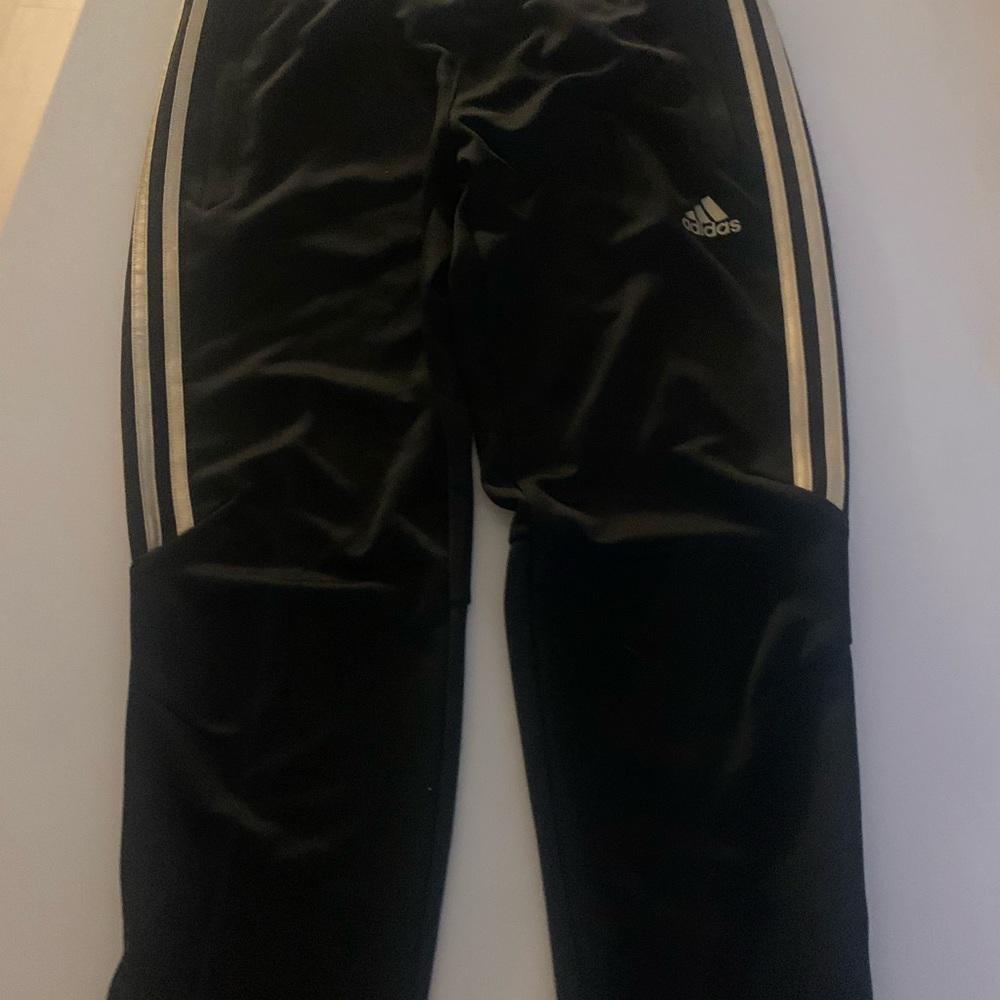 Women’s black and gold Adidas track pants